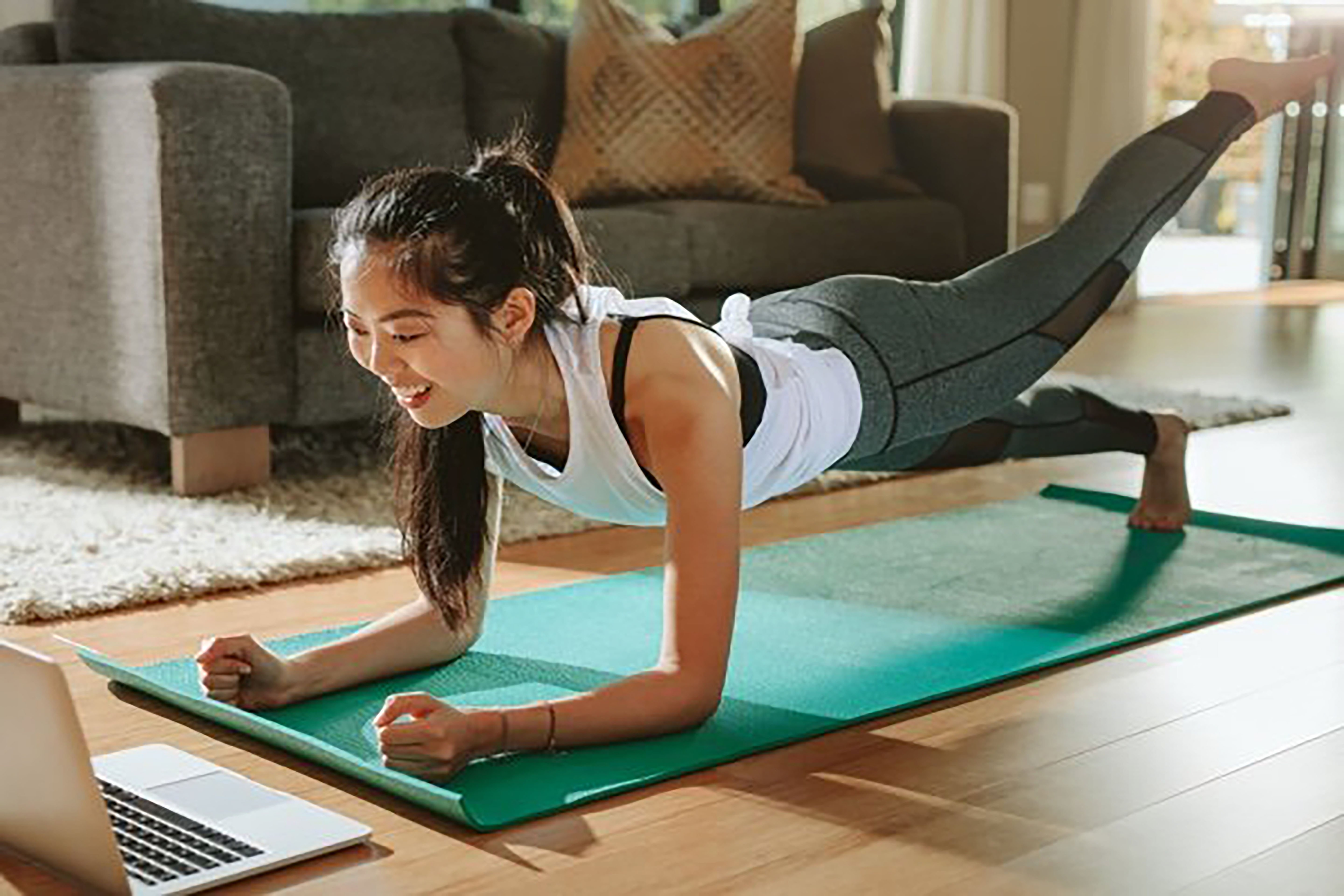 ES_Header-600x430-asian-woman-yoga-mat-exercising-computer-wfh-workout