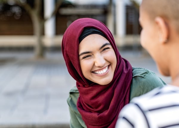 ES_Header-600x430-muslim-woman-smiling-hijab-conversing-with-coworker-outside