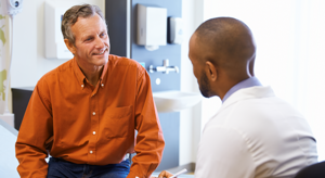 ES_Thumb-300x164-african-american-doctor-white-male-patient-consultation-office-conversation-similing